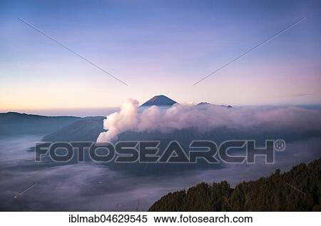 Stock Photography - View of Caldera Tengger with volcanoes at sunrise, smoking volcano Gunung Bromo, with Mt. Batok, Mt. Kursi, Mt. Gunung Semeru, National Park Bromo-Tengger-Semeru, Java, Indonesia, Asia. Fotosearch
