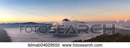 Stock Photography - View of Caldera Tengger with volcanoes at sunrise, smoking volcano Gunung Bromo, with Mt. Batok, Mt. Kursi, Mt. Gunung Semeru, National Park Bromo-Tengger-Semeru, Java, Indonesia, Asia. Fotosearch
