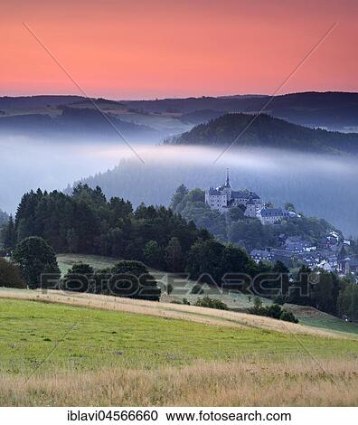 Stock Image - View of castle and village Lauenstein, sunrise, morning mist, Ludwigsstadt, Upper Franconia, Bavaria, Germany, Europe. Fotosearch