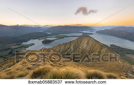 View of mountains and lake from Mount Roy, Roys Peak at sunset, Lake Wanaka, Southern Alps, Otago, South Island, New Zealand, Oceania View Large Photo Image Stock Photo - View of mountains and lake from Mount Roy, Roys Peak at sunset, Lake Wanaka, Southern Alps, Otago, South Island, New Zealand, Oceania. Fotosearch