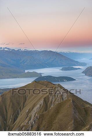 View of mountains and lake from Mount Roy, Roys Peak at sunset, Lake Wanaka, Southern Alps, Otago, South Island, New Zealand, Oceania View Large Photo Image Stock Photograph - View of mountains and lake from Mount Roy, Roys Peak at sunset, Lake Wanaka, Southern Alps, Otago, South Island, New Zealand, Oceania. Fotosearch