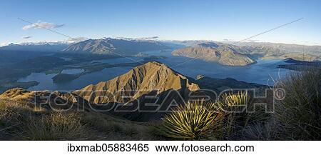 View of mountains and lake from Mount Roy, Roys Peak at sunset, Lake Wanaka, Southern Alps, Otago, South Island, New Zealand, Oceania View Large Photo Image Stock Photography - View of mountains and lake from Mount Roy, Roys Peak at sunset, Lake Wanaka, Southern Alps, Otago, South Island, New Zealand, Oceania. Fotosearch
