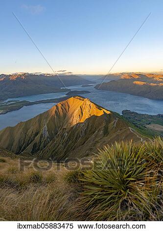 Stock Photography - View of mountains and lake from Mount Roy, Roys Peak at sunset, Lake Wanaka, Southern Alps, Otago, South Island, New Zealand, Oceania. Fotosearch