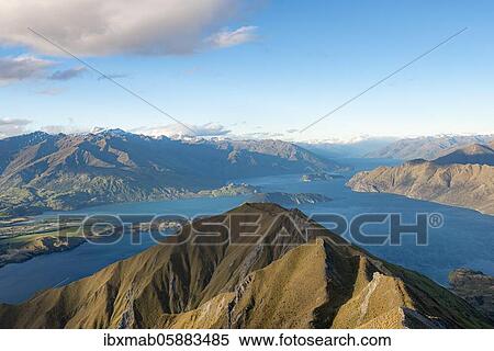 Stock Photography - View of mountains and lake from Mount Roy, Roys Peak in the evening light, Lake Wanaka, Southern Alps, Otago, South Island, New Zealand, Oceania. Fotosearch