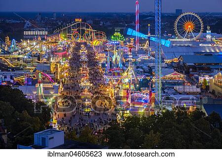 Stock Image - View of the Oktoberfest in the evening, Wiesn, Munich, Upper Bavaria, Bavaria, Germany, Europe. Fotosearch