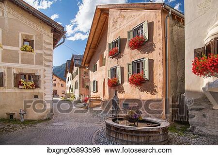 Village square with fountain and typical houses, mountain village Guarda, Inn valley, Lower Engadin, Engadin, Grisons, Switzerland, Europe View Large Photo Image Stock Photograph - Village square with fountain and typical houses, mountain village Guarda, Inn valley, Lower Engadin, Engadin, Grisons, Switzerland, Europe. Fotosearch