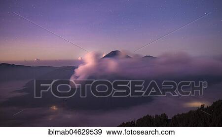 Volcanic landscape at sunrise with starry sky, smoking volcano Gunung Bromo, with Mt. Batok, Mt. Kursi, Mt. Gunung Semeru, National Park Bromo-Tengger-Semeru, Java, Indonesia, Asia View Large Photo Image Stock Photo - Volcanic landscape at sunrise with starry sky, smoking volcano Gunung Bromo, with Mt. Batok, Mt. Kursi, Mt. Gunung Semeru, National Park Bromo-Tengger-Semeru, Java, Indonesia, Asia. Fotosearch