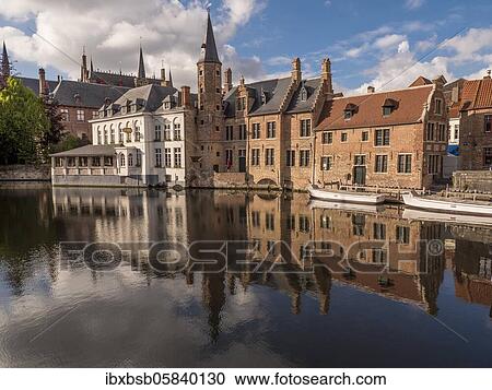 Stock Image - Water reflection of medieval buildings on the water of the Dijver Canal, Bruges, Flanders, Belgium, Europe. Fotosearch