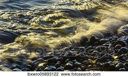 Waves and spray on the beach at sunrise, wave movements at the foot of the chalk cliffs, Baltic Sea, Saßnitz, Rügen, Jasmund National Park, Mecklenburg-Vorpommern, Germany, Europe View Large Photo Image Stock Image - Waves and spray on the beach at sunrise, wave movements at the foot of the chalk cliffs, Baltic Sea, Saßnitz, Rügen, Jasmund National Park, Mecklenburg-Vorpommern, Germany, Europe. Fotosearch
