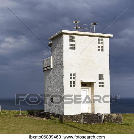 Stock Image - White lighthouse at Cape Bjargtangar, Látrabjarg, Vestfirðir Peninsula, Westfjords, Iceland, Europe. Fotosearch