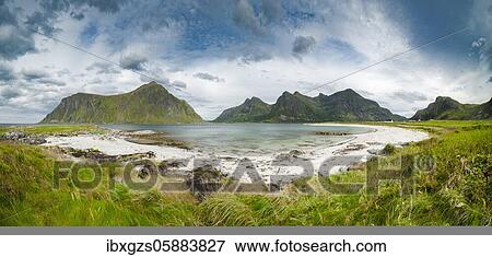 Stock Photo - White sandy beach in front of green mountain peaks near Flakstad, Flakstadøy, Skagsanden, Ramberg, Lofoten, Nordland, Norway, Europe. Fotosearch