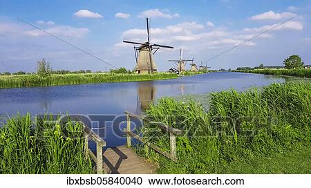 Windmills with water reflection, Kinderdijk, Netherlands View Large Photo Image Stock Image - Windmills with water reflection, Kinderdijk, Netherlands. Fotosearch