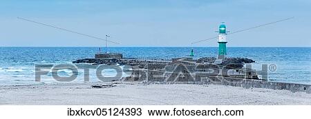 Winter on the beach of the Baltic Sea, West pier with lighthouse, Warnemünde, Rostock, Mecklenburg-Western Pomerania, Germany, Europe View Large Photo Image Stock Image - Winter on the beach of the Baltic Sea, West pier with lighthouse, Warnemünde, Rostock, Mecklenburg-Western Pomerania, Germany, Europe. Fotosearch