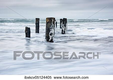 Stock Photography - Winter storm at the Baltic Sea, old groyne in the spray of the surf, near Graal-Müritz, Mecklenburg-Vorpommern, Germany, Europe. Fotosearch
