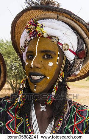 Wodaabe-Bororo man with face painted at the annual Gerewol festival, courtship ritual competition among the Fulani ethnic group, Niger, Africa View Large Photo Image Stock Image - Wodaabe-Bororo man with face painted at the annual Gerewol festival, courtship ritual competition among the Fulani ethnic group, Niger, Africa. Fotosearch