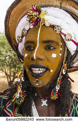 Stock Image - Wodaabe-Bororo man with face painted at the annual Gerewol festival, courtship ritual competition among the Fulani ethnic group, Niger, Africa. Fotosearch