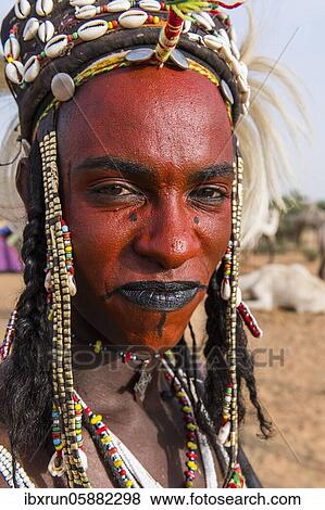 Stock Photo - Wodaabe-Bororo man with face painted at the annual Gerewol festival, courtship ritual competition among the Fulani ethnic group, Niger, Africa. Fotosearch