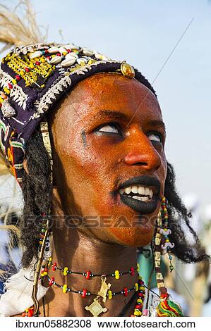 Stock Photo - Wodaabe-Bororo man with face painted at the annual Gerewol festival, courtship ritual competition among the Fulani ethnic group, Niger, Africa. Fotosearch