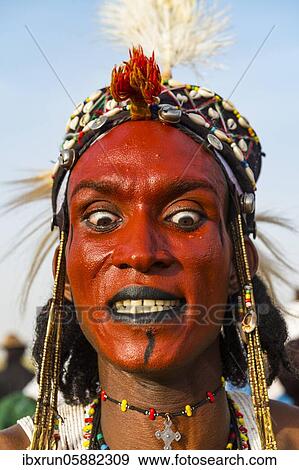 Stock Photo - Wodaabe-Bororo man with face painted at the annual Gerewol festival, courtship ritual competition among the Fulani ethnic group, Niger, Africa. Fotosearch
