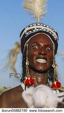 Stock Image - Wodaabe-Bororo man with his face painted at the annual Gerewol festival, courtship ritual competition among the Fulani ethnic group, Niger, Africa. Fotosearch