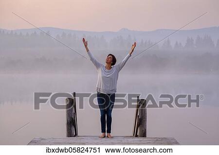 Woman at a jetty, life-affirming, positive, happy, meditating, praying, morning mood at Kirchsee, near Sachsenkam, Upper Bavaria, Bavaria, Germany, Europe View Large Photo Image Stock Image - Woman at a jetty, life-affirming, positive, happy, meditating, praying, morning mood at Kirchsee, near Sachsenkam, Upper Bavaria, Bavaria, Germany, Europe. Fotosearch