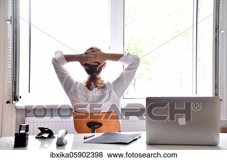 Woman sitting in the office with the window open, Germany, Europe View Large Photo Image Stock Photo - Woman sitting in the office with the window open, Germany, Europe. Fotosearch