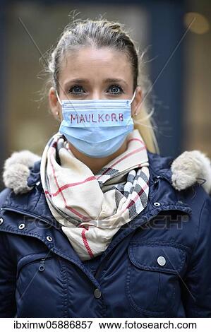 Stock Photo - Woman with inscription MAULKORB on face mask, mask denier, portrait, corona crisis, Stuttgart, Baden-Württemberg, Germany, Europe. Fotosearch