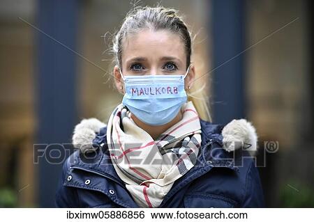 Stock Photograph - Woman with inscription MAULKORB on face mask, mask denier, portrait, corona crisis, Stuttgart, Baden-Württemberg, Germany, Europe. Fotosearch