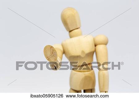 Stock Photograph - Wooden doll, jointed doll stretching out hand, gesture, symbolic image of keeping distance in the Corona crisis, Germany, Europe. Fotosearch