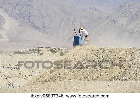Worker with wheelbarrow in the ruins of Caral, oldest city in America, Unesco World Heritage Site, Rio Supe Valley, Peru, South America View Large Photo Image Stock Photograph - Worker with wheelbarrow in the ruins of Caral, oldest city in America, Unesco World Heritage Site, Rio Supe Valley, Peru, South America. Fotosearch