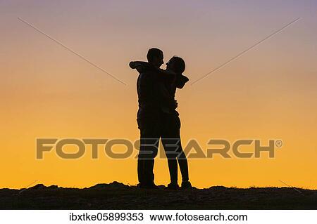 Young couple, dusk, hugging each other, Baden-Württemberg, Germany, Europe View Large Photo Image Stock Image - Young couple, dusk, hugging each other, Baden-Württemberg, Germany, Europe. Fotosearch