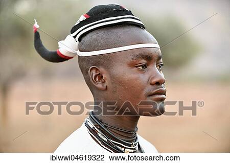 Stock Image - Young Himba man with traditional hairstyle, Portrait, Kaokoveld, Namibia, Africa. Fotosearch