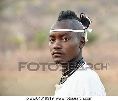 Stock Photo - Young Himba man with traditional hairstyle, Portrait, Kaokoveld, Namibia, Africa. Fotosearch