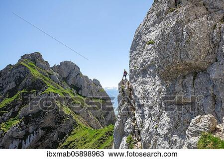 Young man climbing a rock face, via ferrata to the Seekarlspitze, 5-summit via ferrata, hike at the Rofan Mountains, Tyrol, Austria, Europe View Large Photo Image Stock Image - Young man climbing a rock face, via ferrata to the Seekarlspitze, 5-summit via ferrata, hike at the Rofan Mountains, Tyrol, Austria, Europe. Fotosearch