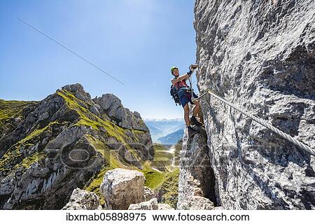 Young man climbing a rock face, via ferrata to the Seekarlspitze, 5-summit via ferrata, hike at the Rofangebirge, Tyrol, Austria, Europe View Large Photo Image Stock Photography - Young man climbing a rock face, via ferrata to the Seekarlspitze, 5-summit via ferrata, hike at the Rofangebirge, Tyrol, Austria, Europe. Fotosearch