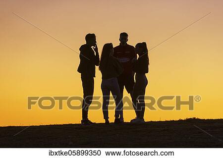 Young woman and men, twilight, talking, Baden-Württemberg, Germany, Europe View Large Photo Image Stock Image - Young woman and men, twilight, talking, Baden-Württemberg, Germany, Europe. Fotosearch