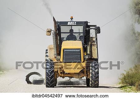 A tractor pulling tyres for grading the parks gravel roads, Kalahari Desert, Kgalagadi Transfrontier Park, South Africa, Africa View Large Photo Image Stock Photo - A tractor pulling tyres for grading the parks gravel roads, Kalahari Desert, Kgalagadi Transfrontier Park, South Africa, Africa. Fotosearch