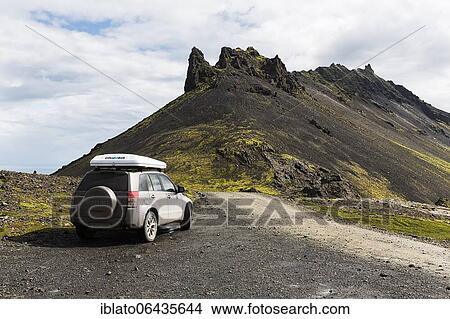 Picture - All-terrain vehicle with roof tent next to gravel road on Stapafell mountain, barren volcanic landscape, Arnarstapi, Snæfellsnes peninsula, Iceland, Europe. Fotosearch
