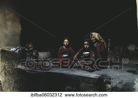 An old woman, two girls and an infant in the smokehouse of a traditional mud house, the girls drinking milk tea, Sarad-e-Broghil, Wakhan Corridor, Afghanistan, Asia View Large Photo Image Stock Image - An old woman, two girls and an infant in the smokehouse of a traditional mud house, the girls drinking milk tea, Sarad-e-Broghil, Wakhan Corridor, Afghanistan, Asia. Fotosearch