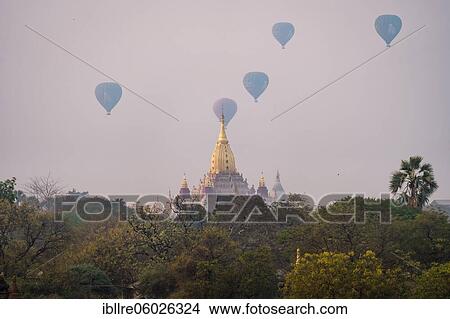 Picture - Ananda temple with several colorful balloons, Old Bagan, Myanmar, Asia. Fotosearch