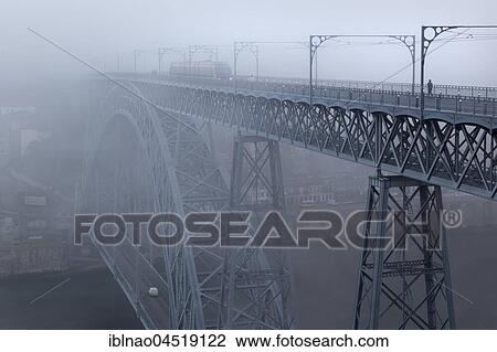 Stock Image - Arch bridge Ponte Dom Luís I over the Douro, foggy weather, Porto, Portugal, Europe. Fotosearch