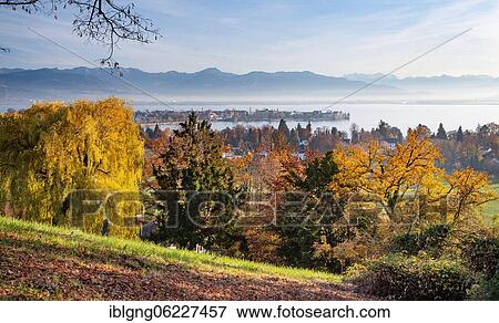 Stock Photo - Autumn landscape above the lake with old town island in front of the Alps, Lindau, Lake Constance, Swabia, Bavaria, Germany, Europe. Fotosearch