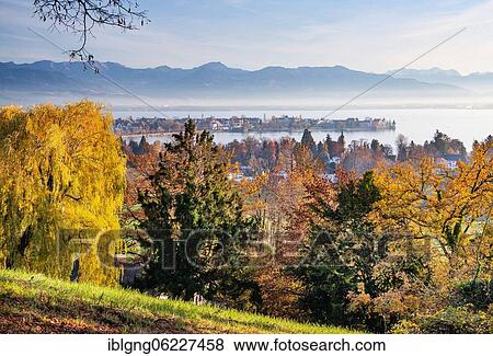 Stock Photo - Autumn landscape above the lake with old town island in front of the Alps, Lindau, Lake Constance, Swabia, Bavaria, Germany, Europe. Fotosearch