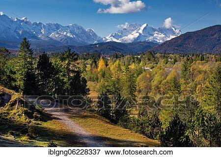 Stock Photo - Autumn landscape in the Isar valley with Alpspitze and Zugspitze in the Wetterstein range, Wallgau, Isar, Werdenfelser Land, Alpenwelt Karwendel, Upper Bavaria, Bavaria, Germany, Europe. Fotosearch