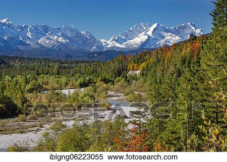 Stock Photography - Autumn landscape in the Isar valley with Alpspitze and Zugspitze in the Wetterstein range, Wallgau, Isar, Werdenfelser Land, Alpenwelt Karwendel, Upper Bavaria, Bavaria, Germany, Europe. Fotosearch
