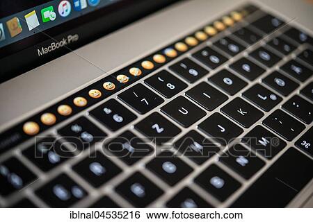 Backlit keyboard and Touch Bar showing emoticons, laptop, Apple MacBook Pro, close-up View Large Photo Image Stock Photograph - Backlit keyboard and Touch Bar showing emoticons, laptop, Apple MacBook Pro, close-up. Fotosearch