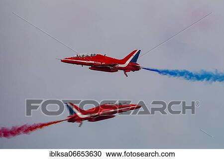 Stock Image - BAE Systems Hawk two aircraft of the Royal Air Force Red Arrows display team in flight, Cambridgeshire, England, United Kingdom, Europe. Fotosearch
