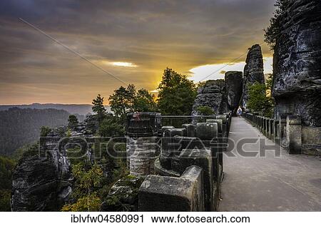 Bastei bridge, Bastei at sunrise, Elbe Sandstone Mountains, Rathen, National Park Saxon Switzerland, Saxony, Germany, Europe View Large Photo Image Stock Image - Bastei bridge, Bastei at sunrise, Elbe Sandstone Mountains, Rathen, National Park Saxon Switzerland, Saxony, Germany, Europe. Fotosearch