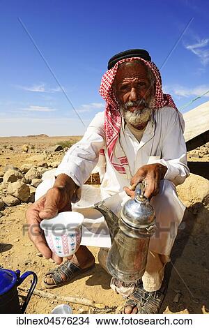 Bedouin preparing coffee with pan-roasted beans and kardamom, Jordan, Asia View Large Photo Image Picture - Bedouin preparing coffee with pan-roasted beans and kardamom, Jordan, Asia. Fotosearch