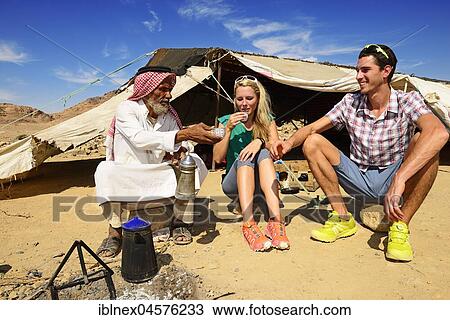 Stock Image - Bedouin preparing coffee with pan-roasted beans and kardamom, Jordan, Asia. Fotosearch